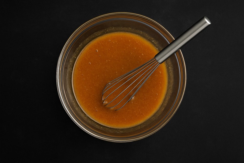 In a medium bowl, mix together brown sugar, honey, mustard, ground cloves, and reserved pineapple juice until smooth and well combined.