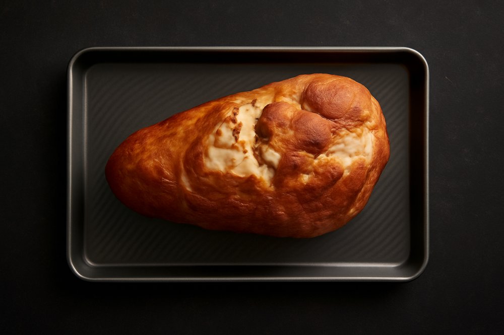 Preheat the oven to 325°F (165°C) and place the ham, cut-side down, into a roasting pan.