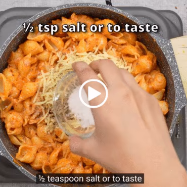 Pouring vodka into the tomato base to create the signature Gigi Hadid pasta recipe